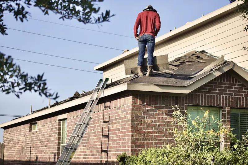 Professional roofer working on a residential roof in Belmont